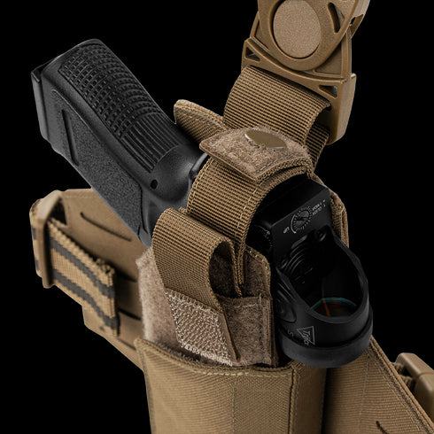 The Condor LCS RDS Leg Holster securely holds a black handgun with mounted sight in a tan tactical holster with strap and Velcro closure, ideal for law enforcement or military professionals.